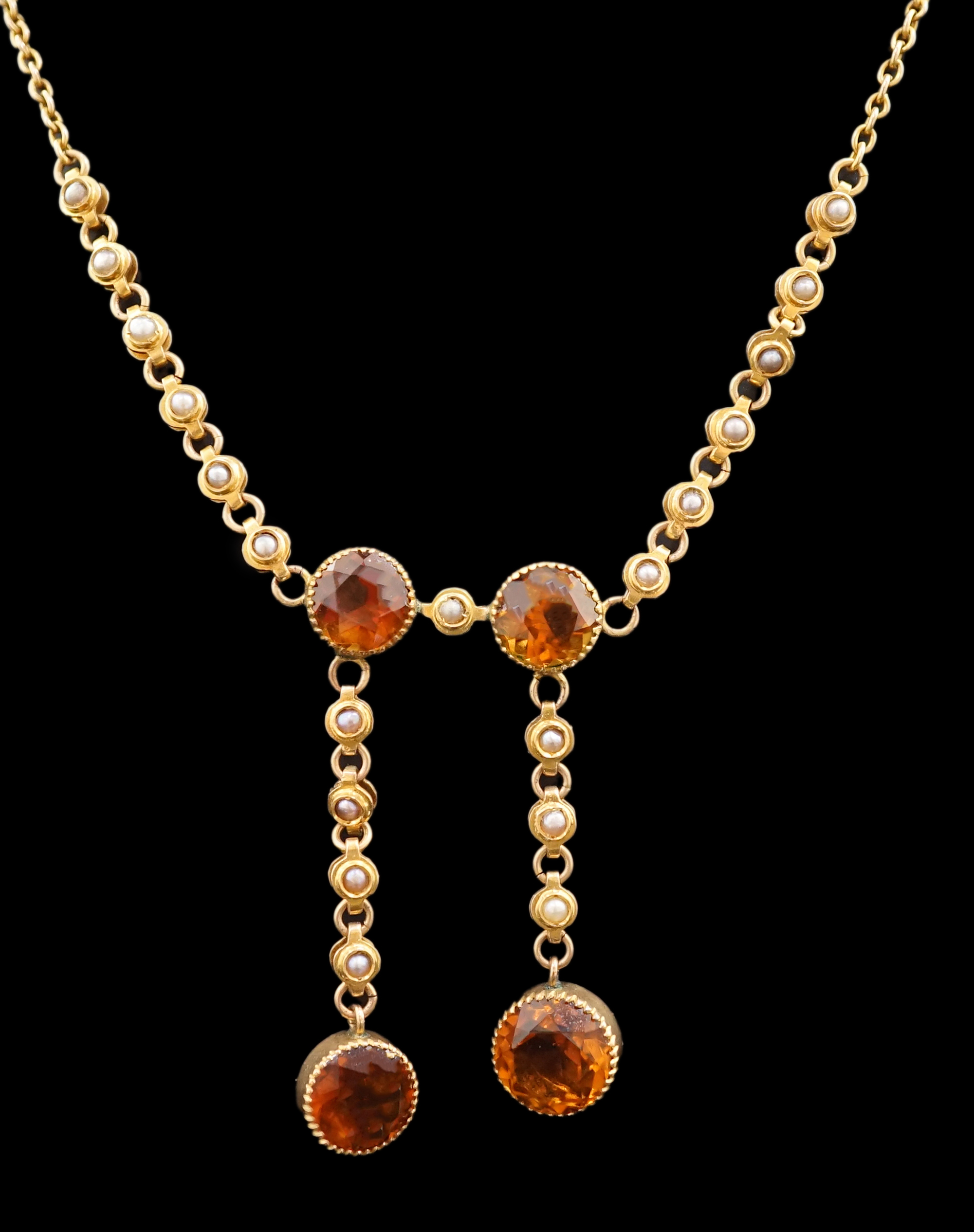 An Edwardian 15ct gold, seed pearl and citrine graduated double drop necklace